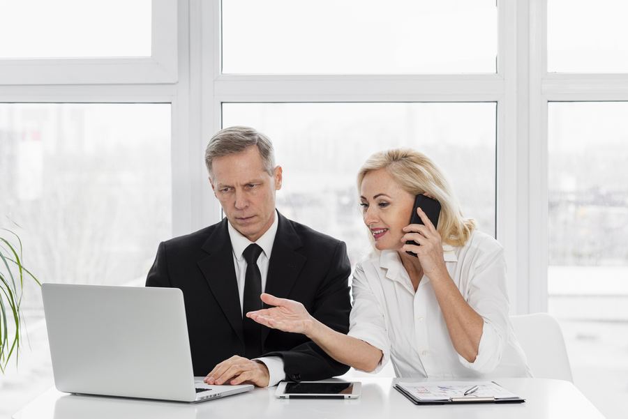 Business professionals at a desk reviewing PCI DSS scope