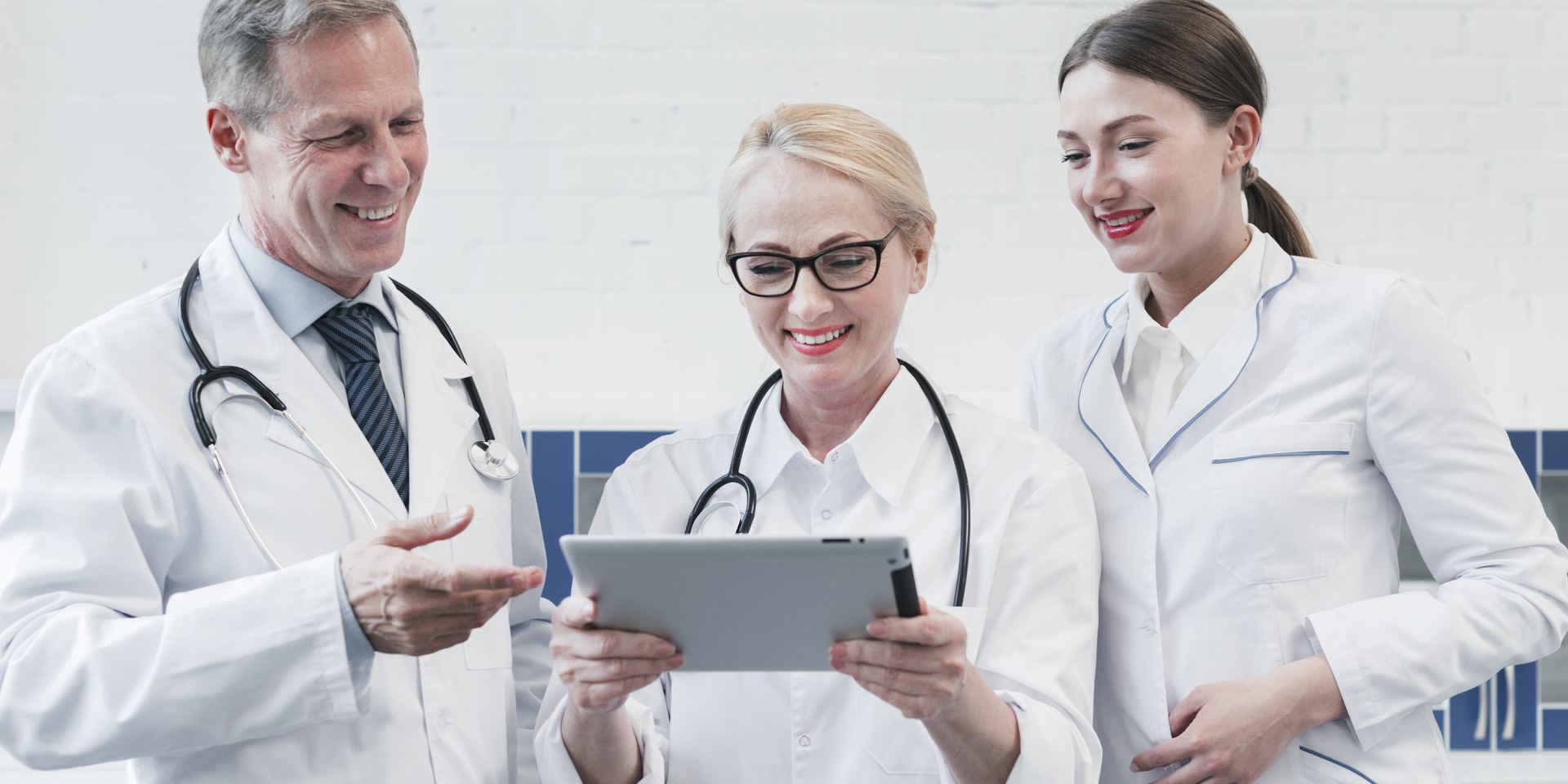 Two doctors reviewing a compliance checklist on tablets, healthcare cybersecurity