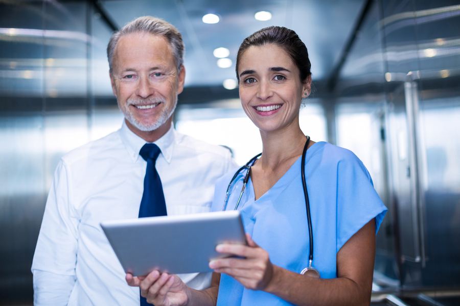 Physician and nurse reviewing patient records, Microsoft 365 email security for healthcare