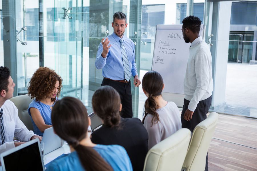Business team in suits at a whiteboard, email security for law and real estate firms