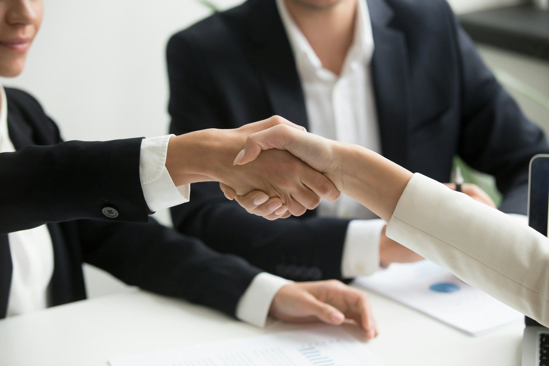 Business professionals shaking hands after a cybersecurity consultation