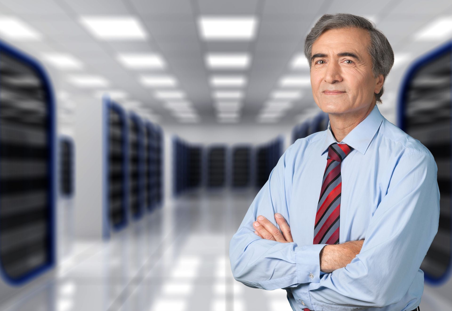 Security professional in shirt and tie standing in a bright data center