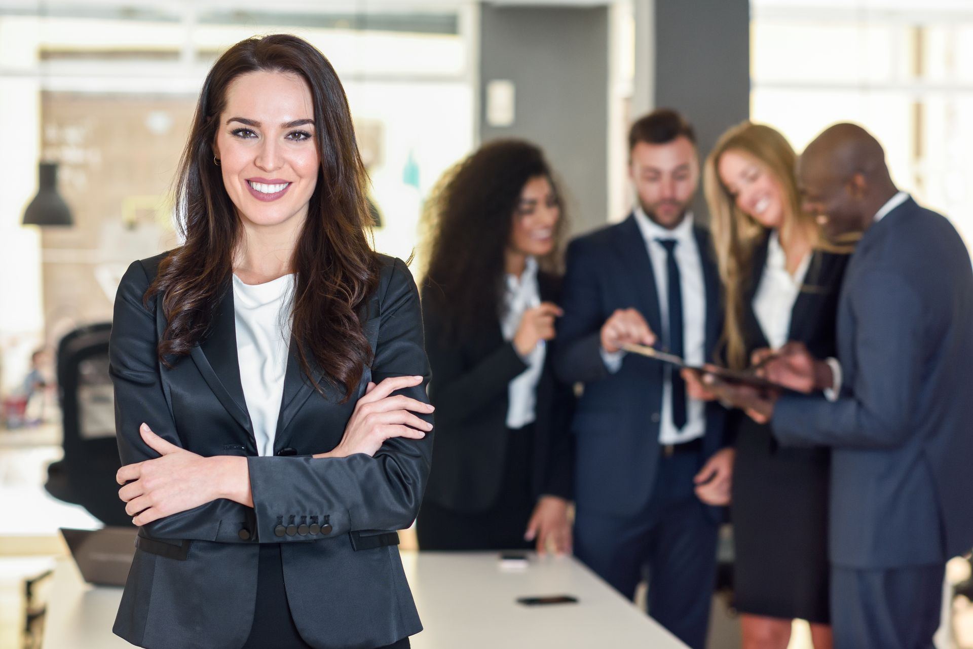 Business leader in a suit with her executive team