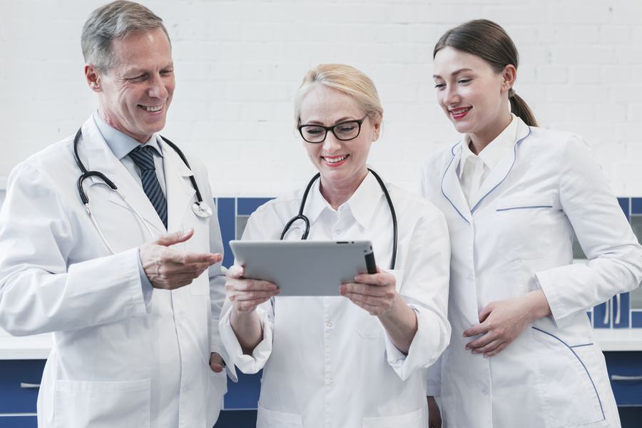 Healthcare and dental clinic team reviewing patient privacy on a tablet