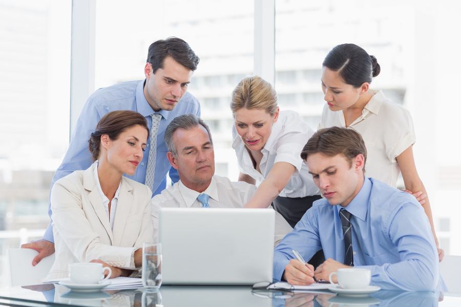Law firm team meeting around a laptop