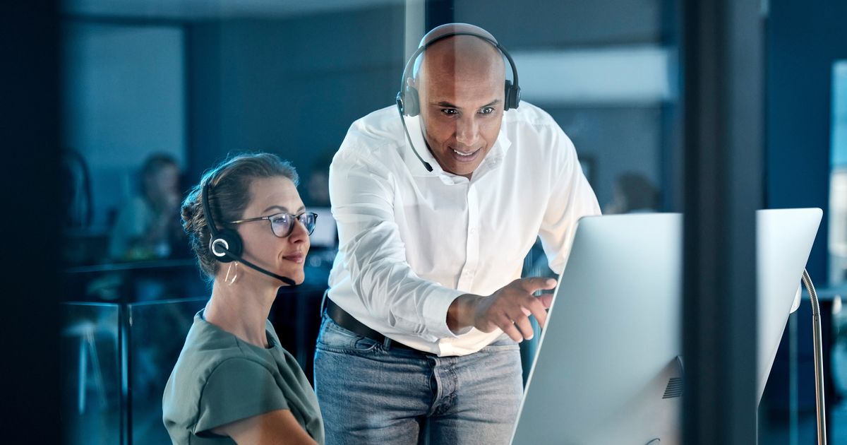 The Cybersecurity Executive Summary Every CEO and IT Manager Should See 8 Help desk supervisor and agent at a service desk, illustrating the M&S cyberattack and password reset risk