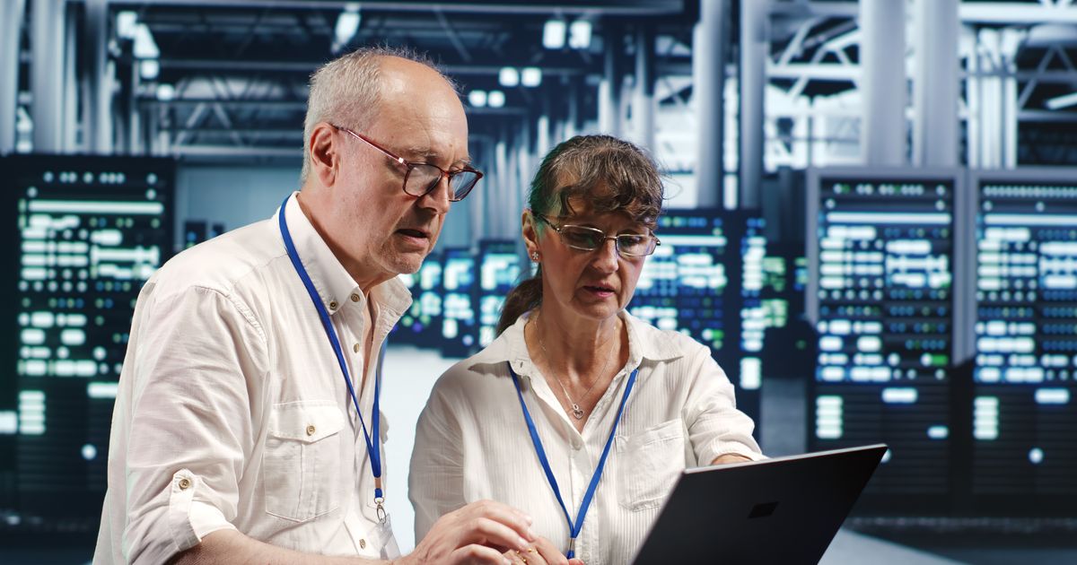 The Cybersecurity Executive Summary Every CEO and IT Manager Should See 2 Two engineers reviewing systems on a laptop in a data center, illustrating the Salesloft Drift breach