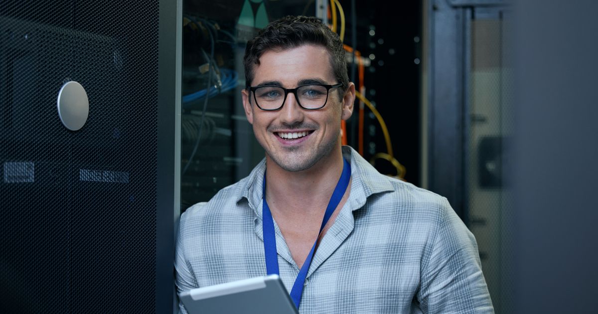 The Cybersecurity Executive Summary Every CEO and IT Manager Should See 4 IT engineer with a tablet in a server room, illustrating the SharePoint ToolShell attacks on on-premises servers